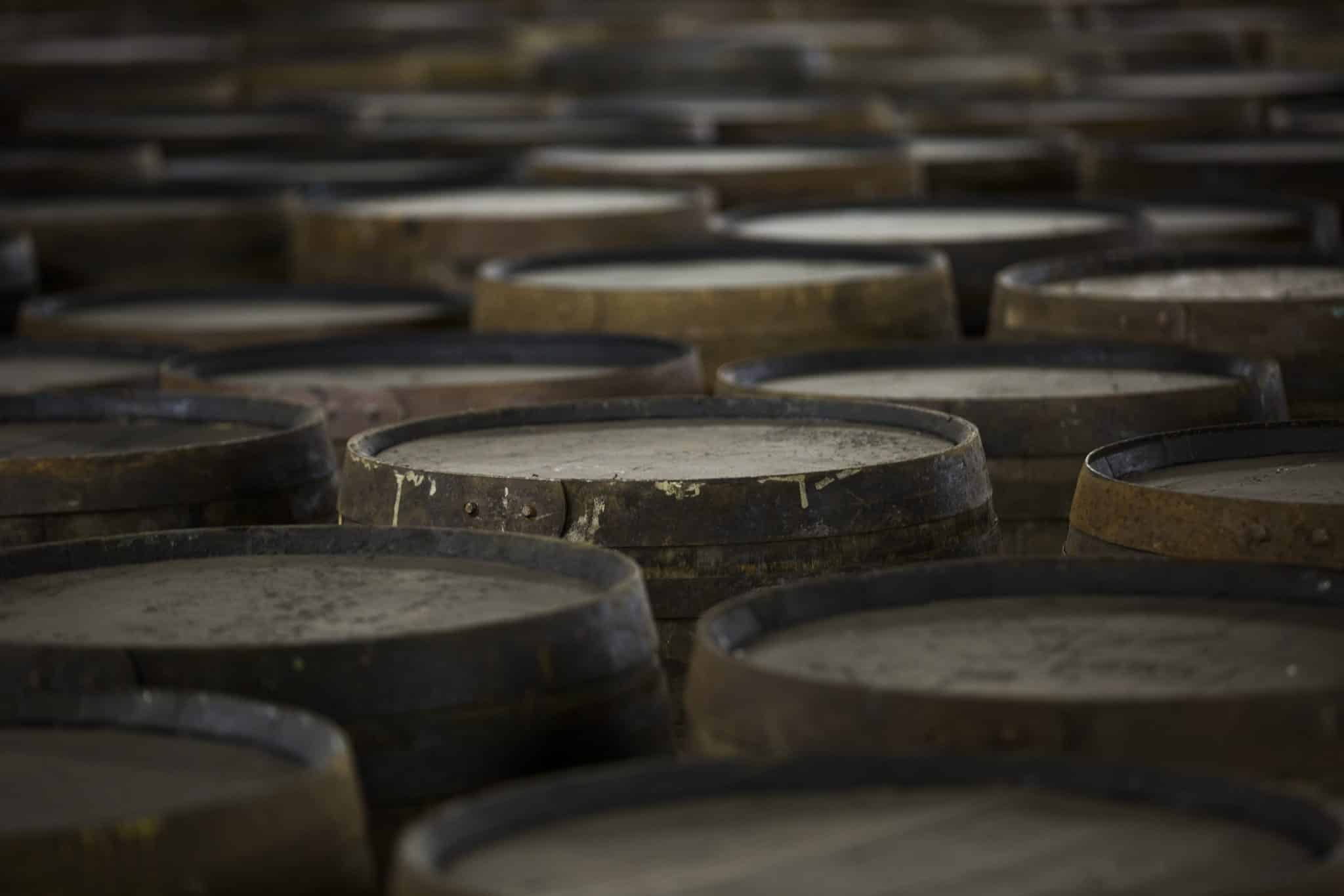 Rows of wooden whisky casks in whisky distillery Rows of wooden whisky casks in whisky distillery